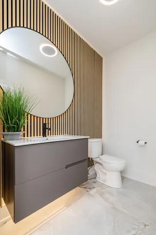 a bathroom with a toilet and a mirror