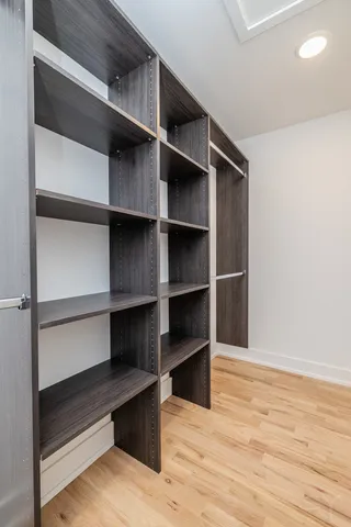 a view of walk in closet with empty racks