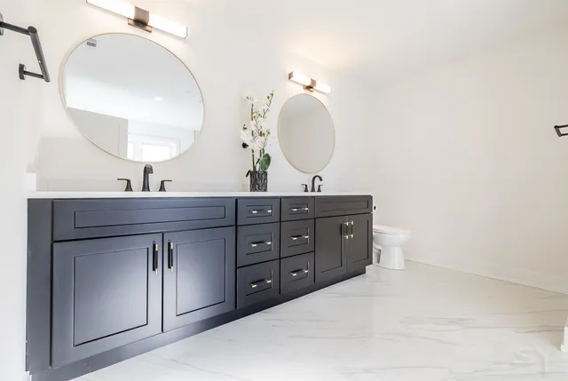 a spacious bathroom with a double vanity sink and a mirror