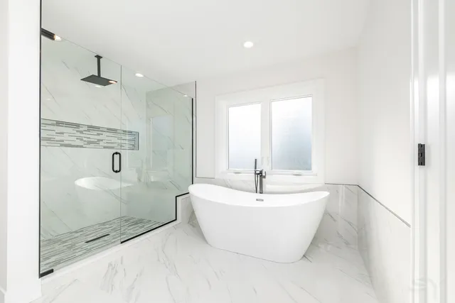 a bathroom with a bathtub and shower