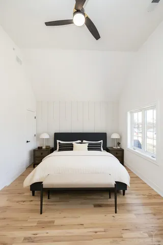 a bedroom with a bed and wooden floor
