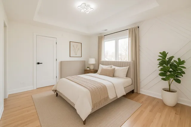 a bedroom with a large bed and a potted plant