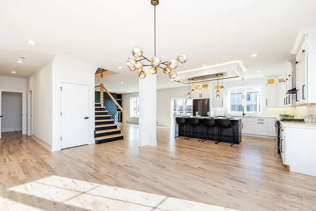 a view of a kitchen with cabinets and wooden floor