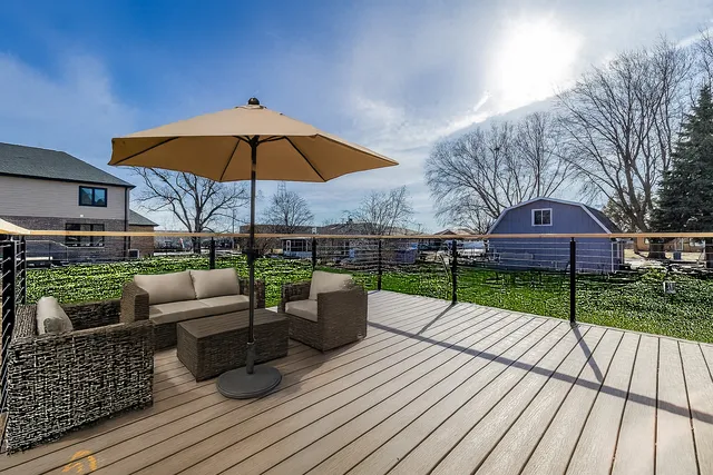 a view of house with backyard outdoor seating and wooden floor