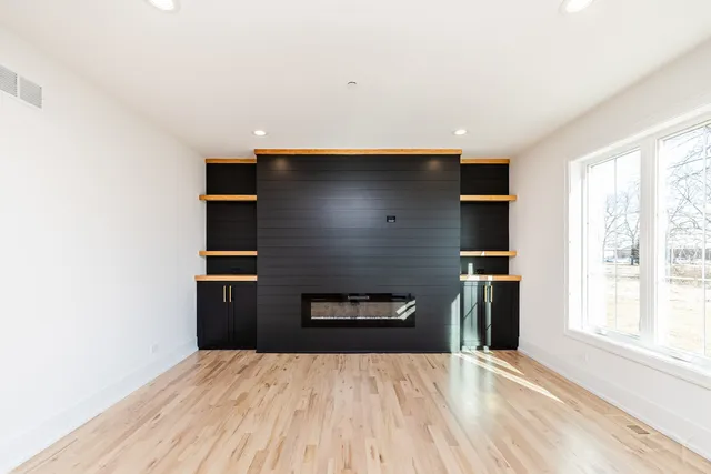 a kitchen with granite countertop a refrigerator and a stove top oven
