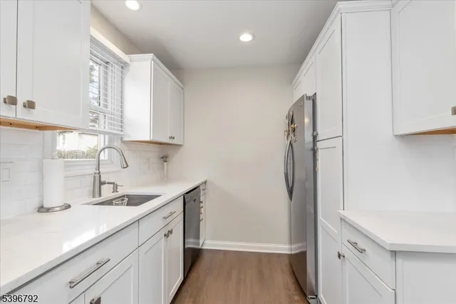 a kitchen with a sink and a refrigerator