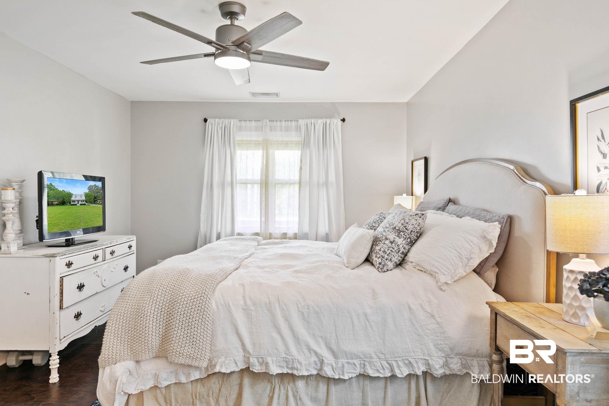 22810 High Ridge Road Fairhope, AL 36532 - Photo 35 of 78 Bedroom featuring a ceiling fan with integrated lighting, window with white draperies, and light-toned walls