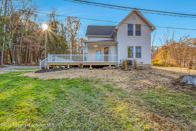 a view of a balcony with wooden floor and fence
