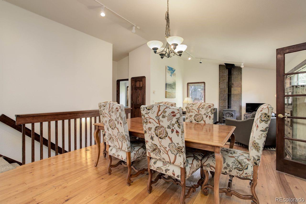 264 North Fork Road Grant, CO 80448 - Photo 11 of 34 a view of a dining room with furniture wooden floor and chandelier