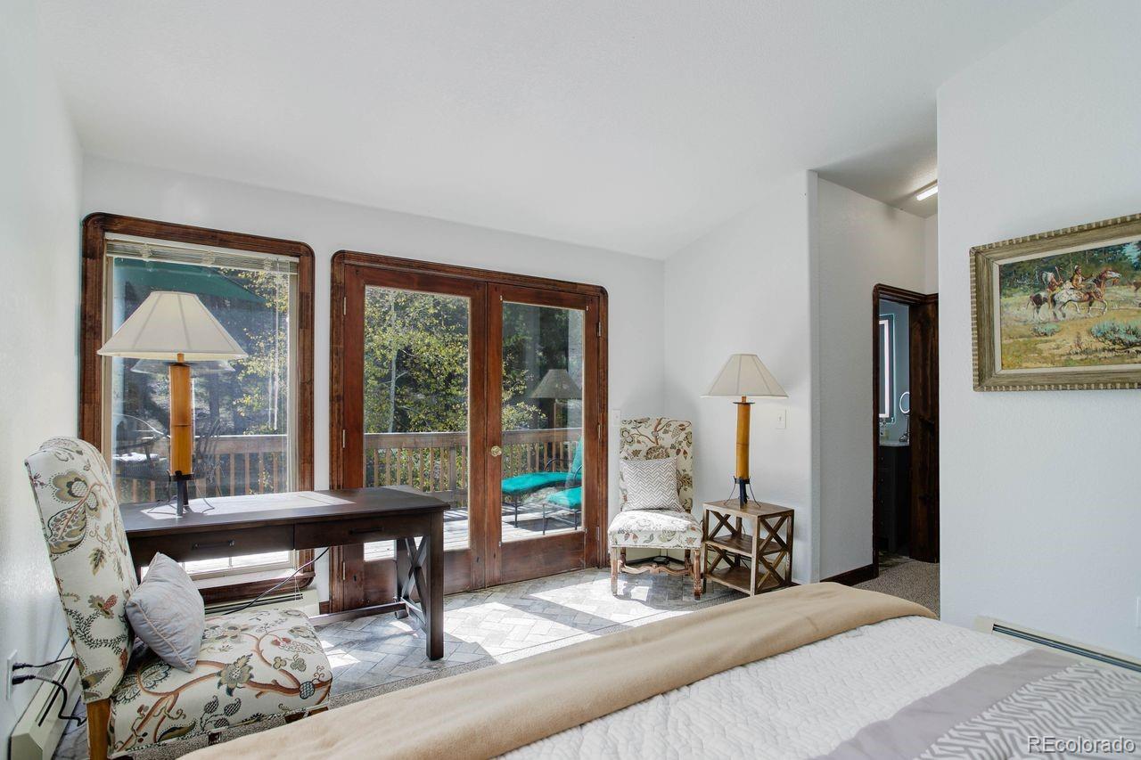 264 North Fork Road Grant, CO 80448 - Photo 14 of 34 a living room with furniture and large windows