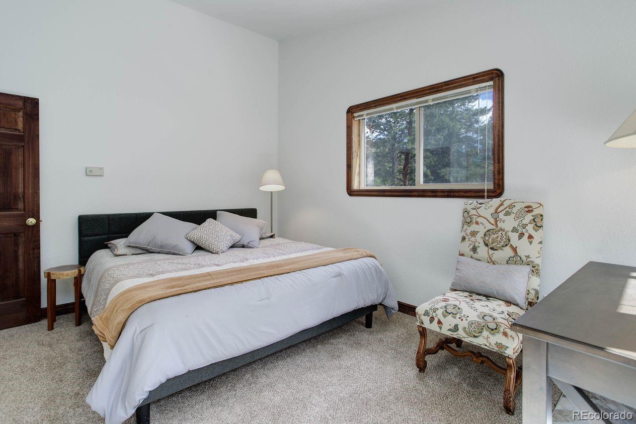 264 North Fork Road Grant, CO 80448 - Photo 15 of 34 a bedroom with bed and a window