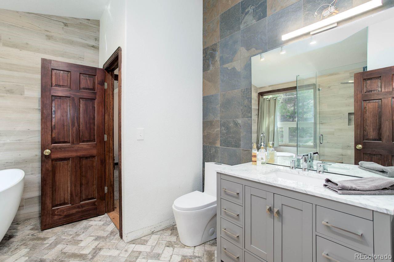 264 North Fork Road Grant, CO 80448 - Photo 17 of 34 a bathroom with a toilet sink and mirror