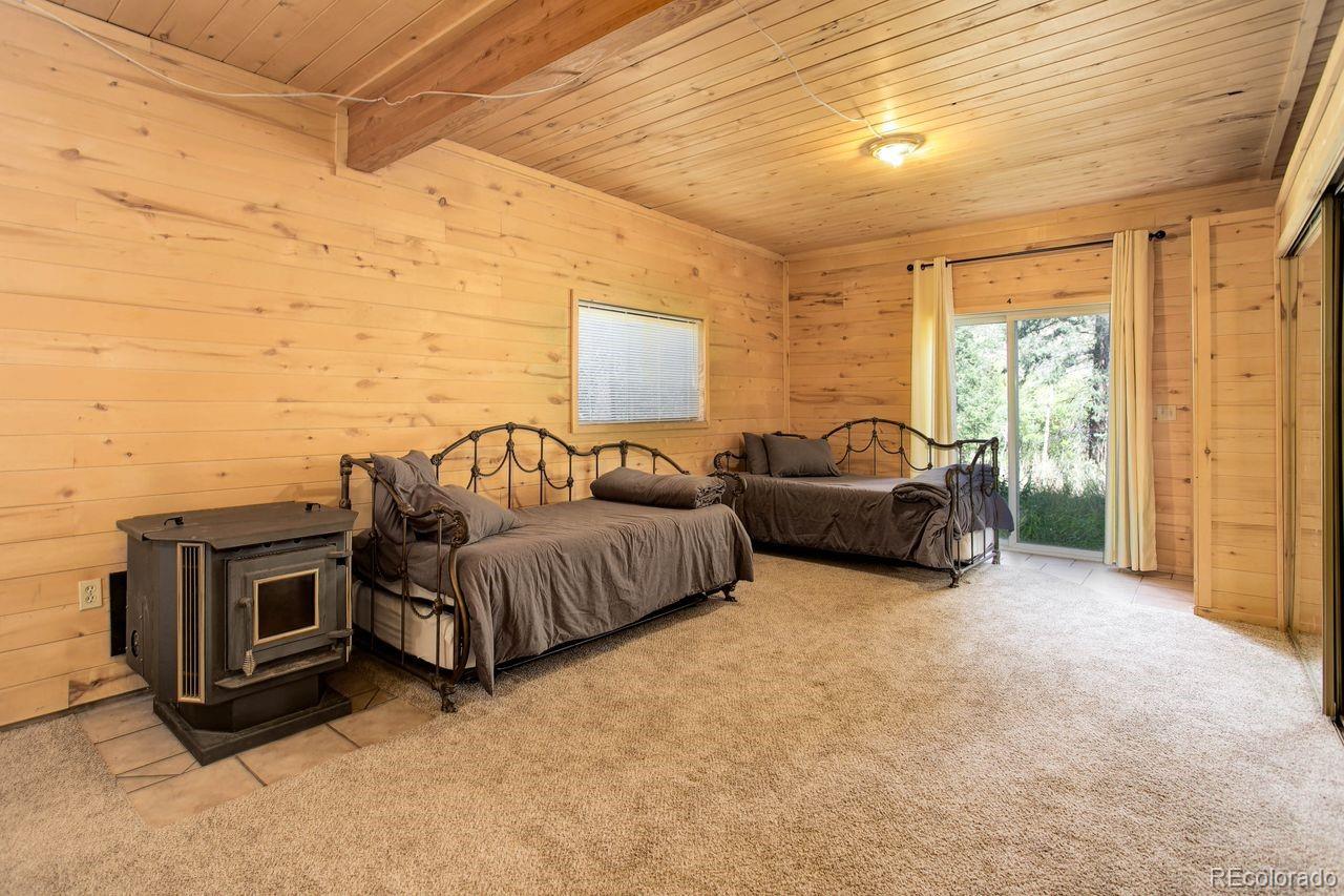 264 North Fork Road Grant, CO 80448 - Photo 21 of 34 a spacious bedroom with a bed and a couch
