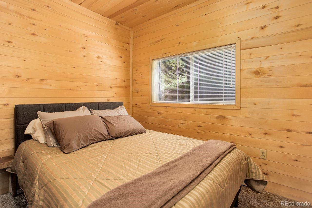 264 North Fork Road Grant, CO 80448 - Photo 22 of 34 a bedroom with a bed and a window