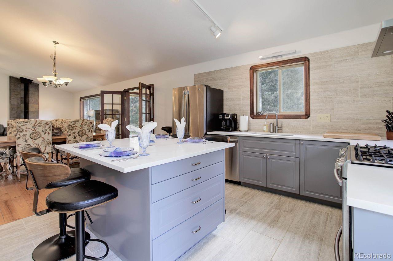 264 North Fork Road Grant, CO 80448 - Photo 5 of 34 a kitchen with a sink cabinets and dining table