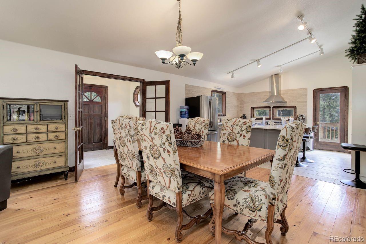 264 North Fork Road Grant, CO 80448 - Photo 9 of 34 a view of a dining room with furniture window and wooden floor