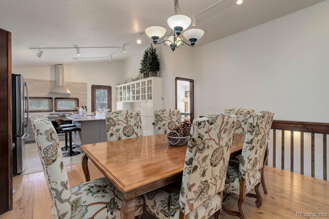 264 North Fork Road Grant, CO 80448 - Photo 10 of 34 a view of a dining room with furniture and chandelier