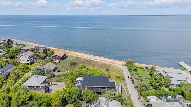 an aerial view of a house with a yard and lake view