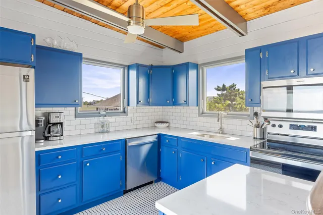 a kitchen with stainless steel appliances granite countertop wooden cabinets a sink and dishwasher