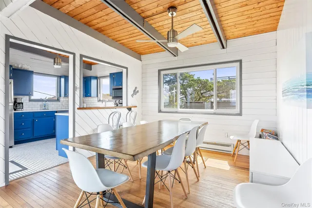 a dining room with furniture and wooden floor