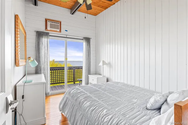 a bedroom with a bed and a large window with the outer view