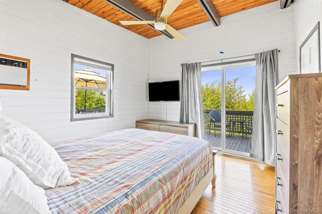 a bedroom with a bed and glass window