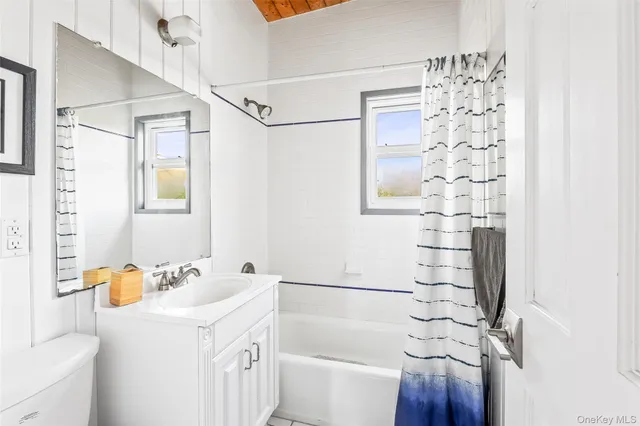 a bathroom with a sink a vanity and shower