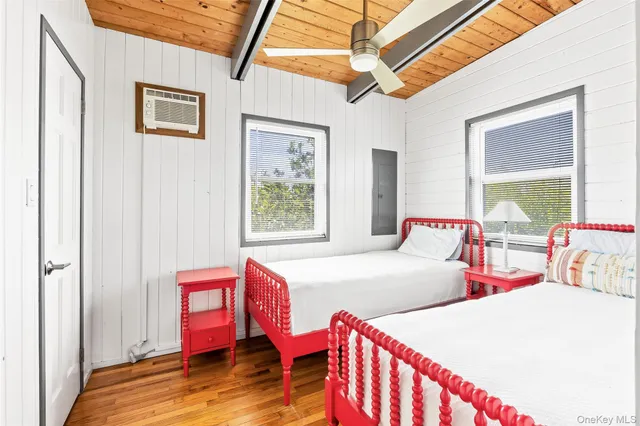 a bed room with two beds and a window