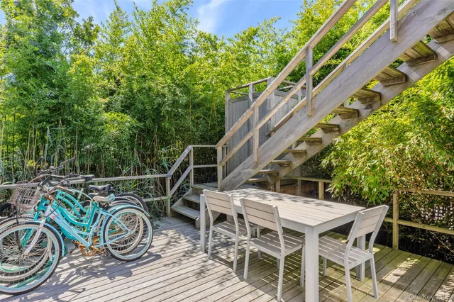 a view of house with deck and outdoor seating
