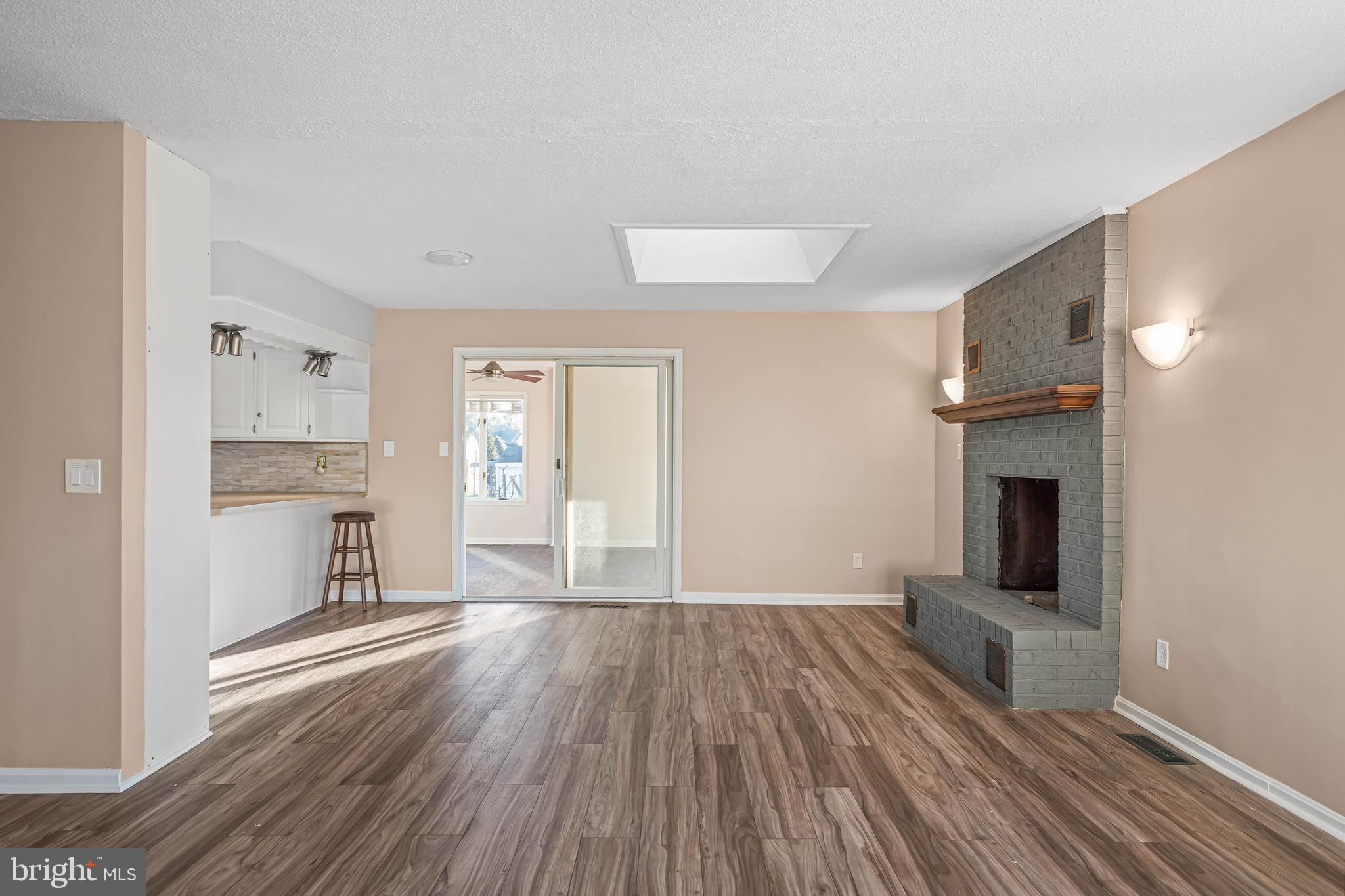 521 Harbor Road Ocean View, DE 19970 - Photo 11 of 32 a view of a kitchen with wooden floor and a kitchen