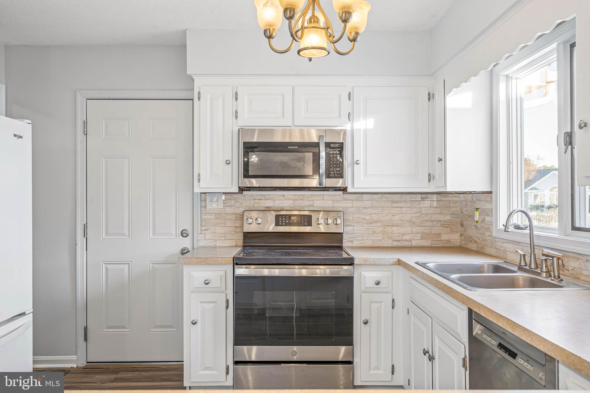 521 Harbor Road Ocean View, DE 19970 - Photo 17 of 32 a kitchen with a sink stove and microwave