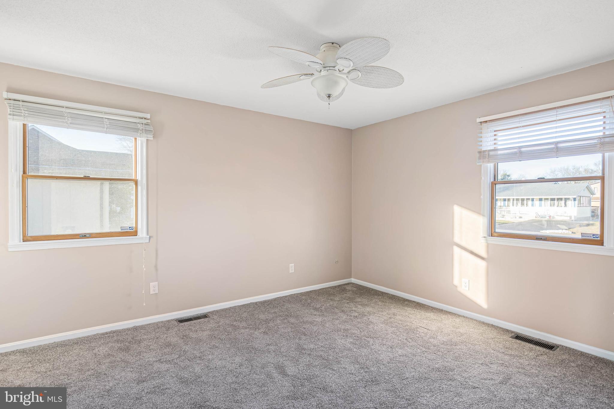 521 Harbor Road Ocean View, DE 19970 - Photo 22 of 32 an empty room with a window and a fan