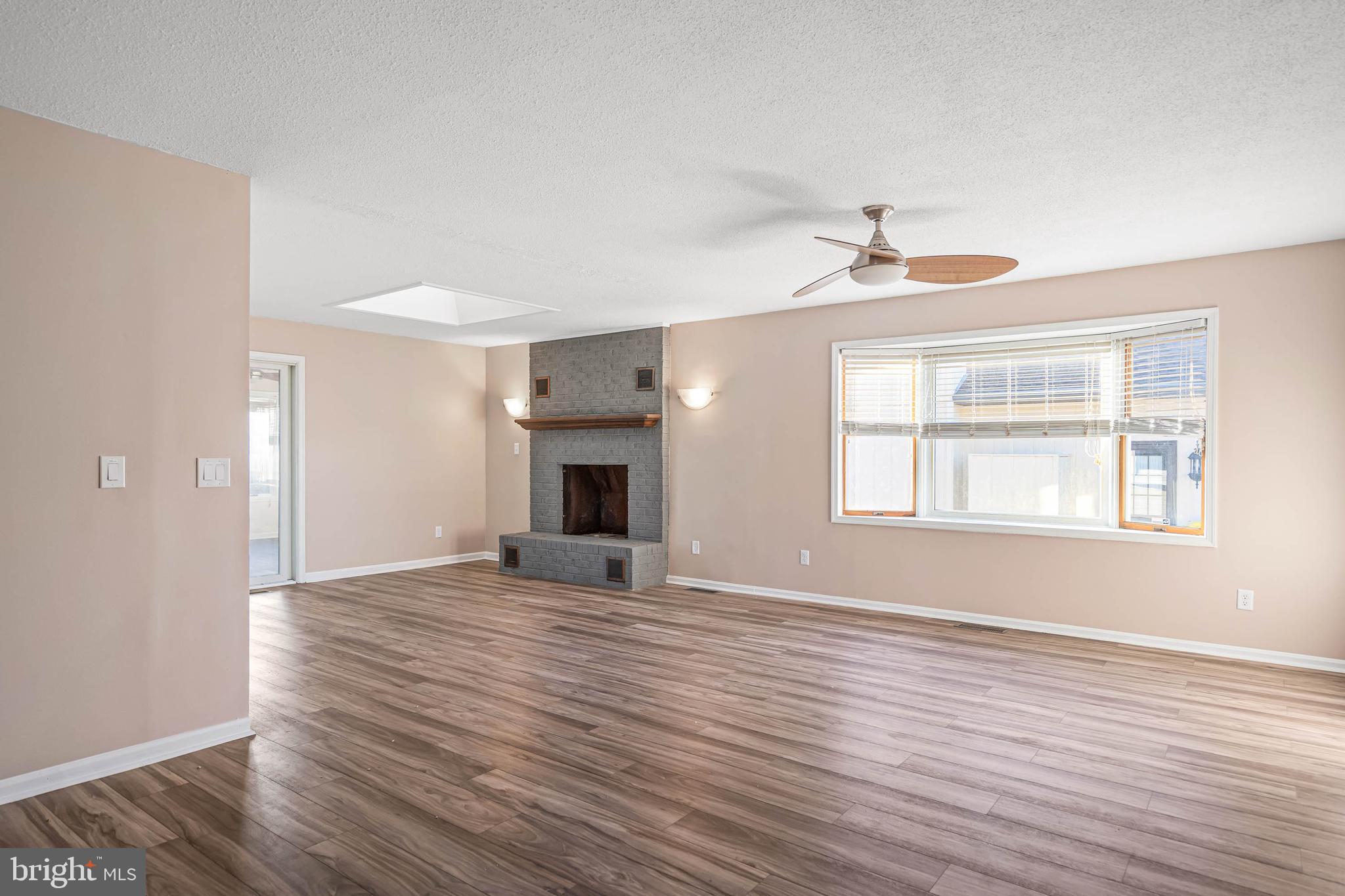 521 Harbor Road Ocean View, DE 19970 - Photo 8 of 32 a view of an empty room with window and wooden floor