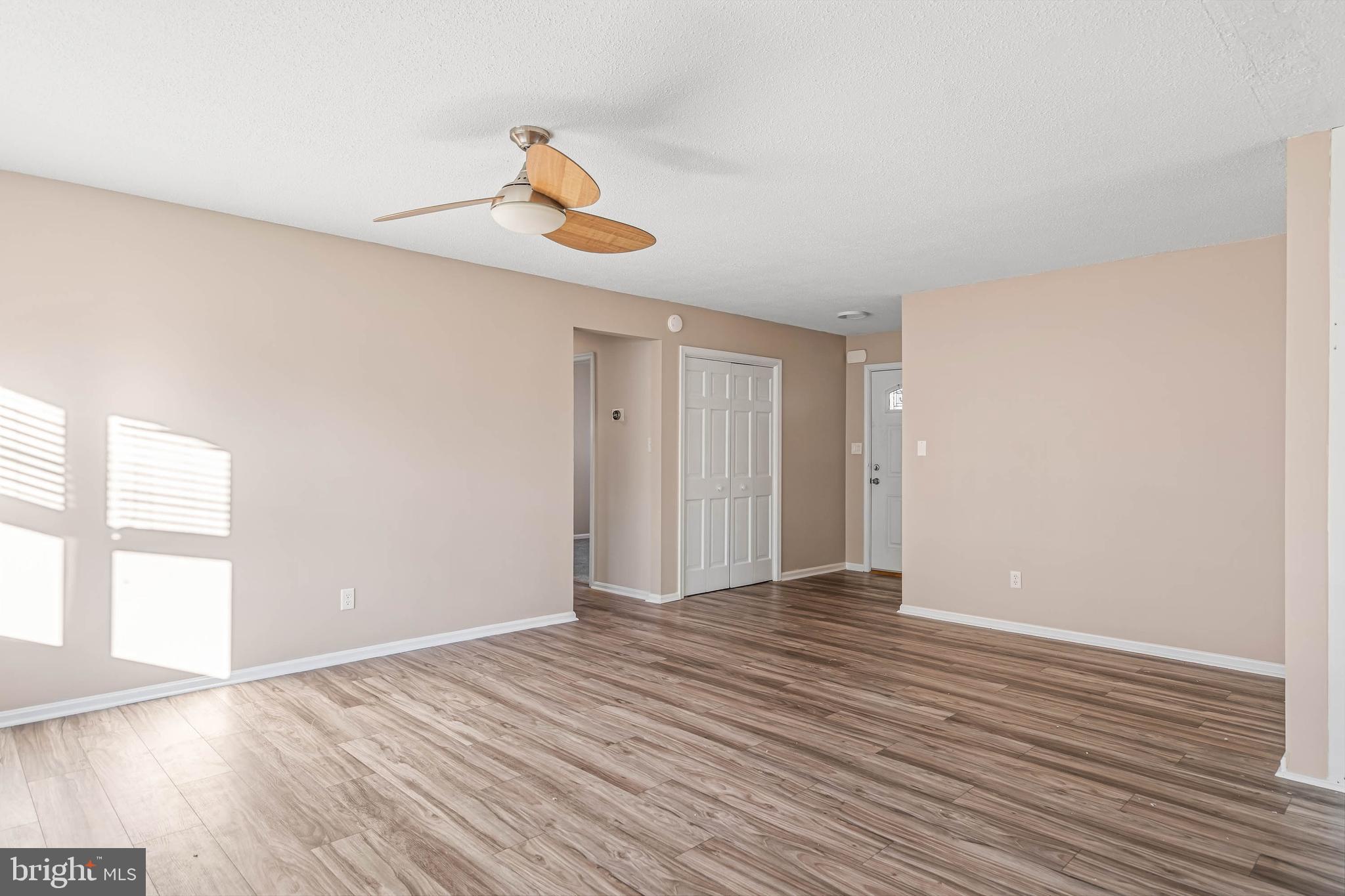 521 Harbor Road Ocean View, DE 19970 - Photo 9 of 32 a view of an empty room with wooden floor and a window
