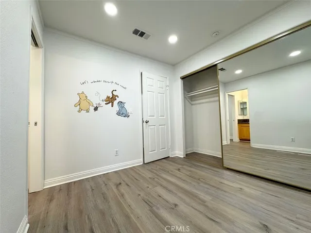 a view of hallway with wooden floor