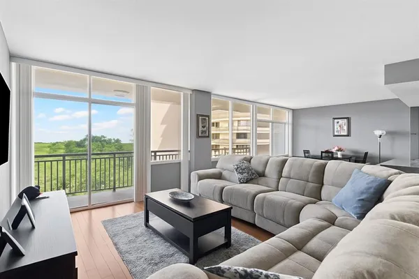 a living room with furniture and a floor to ceiling window