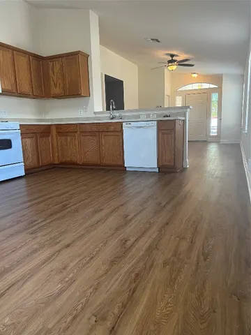 a kitchen with stainless steel appliances wooden cabinets and a sink