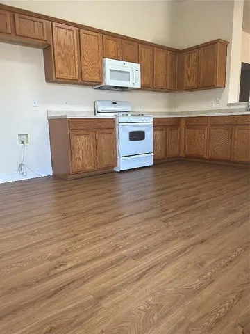 a kitchen with granite countertop a sink and a stove top oven