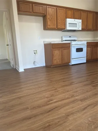 a view of kitchen with stainless steel appliances granite countertop a stove a sink and a refrigerator
