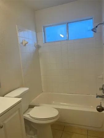 a bathroom with a toilet and a tub