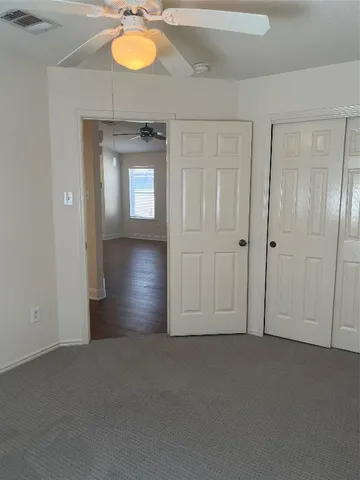 an empty room with windows and closet