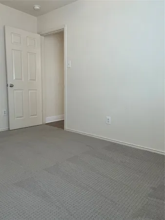 a view of a yard with a large tree