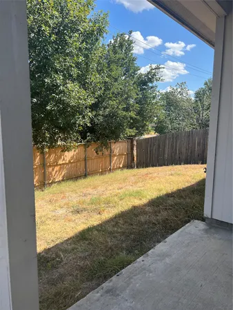 a view of a backyard of the house