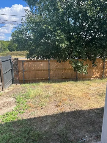 a view of a backyard of the house