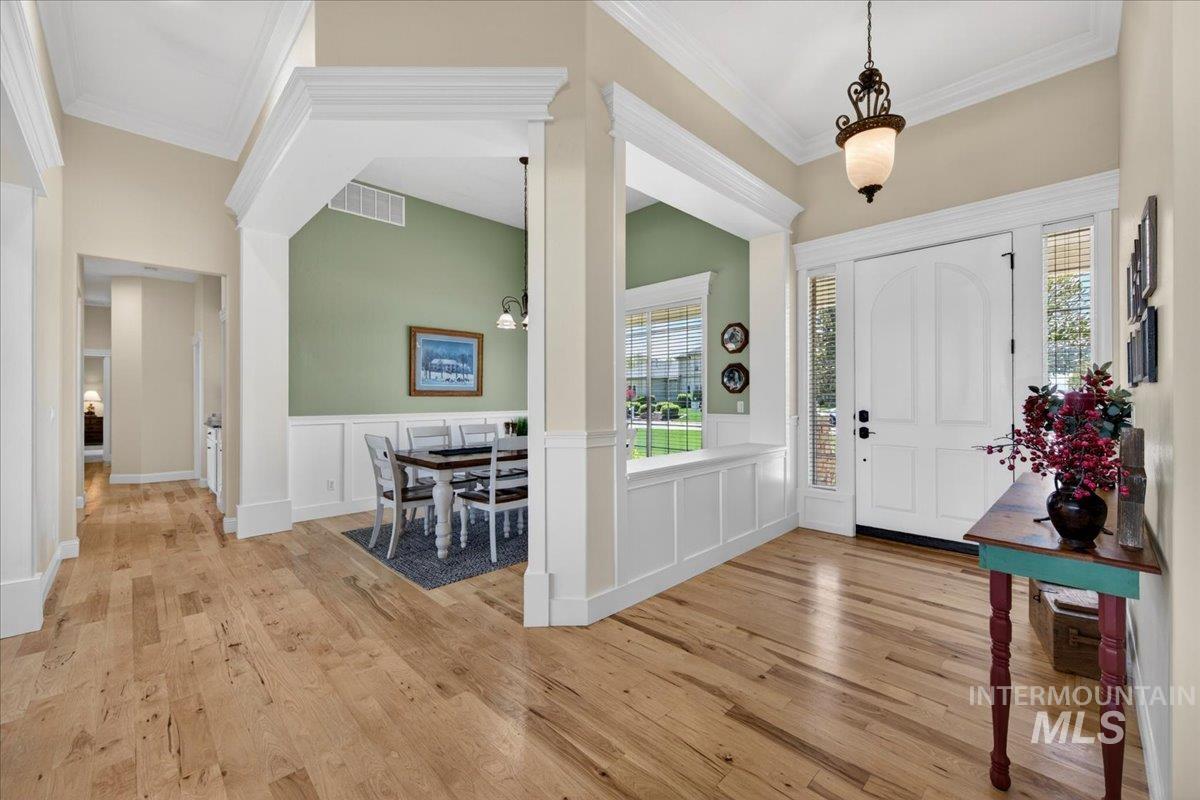 414 East Shafer View Drive Meridian, ID 83642 - Photo 5 of 50 Newer Natural Hickory Hardwood flooring throughout the entryway, hallways, great room, formal & informal dining areas, & kitchen. Decorative Entry Lighting, Beautiful Moldings & Finished Woodwork with 12ft. Ceilings in Entry & Formal Dining area.