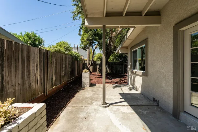 a view of a patio with table and chairs and potted plants