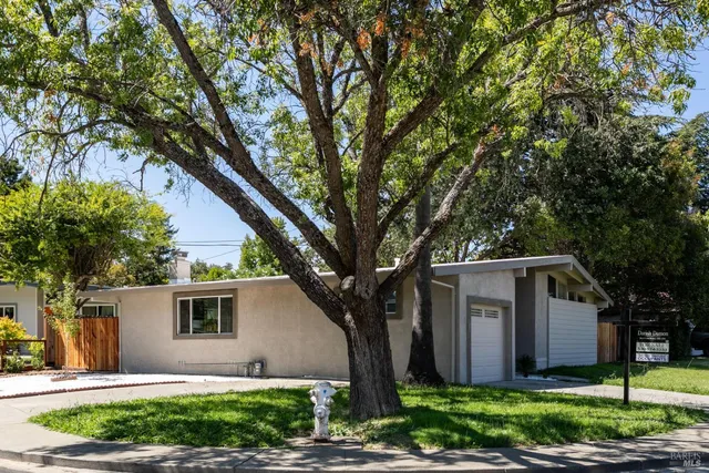 a front view of house with yard and trees