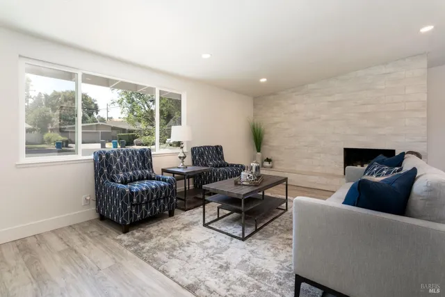 a living room with furniture and a fireplace