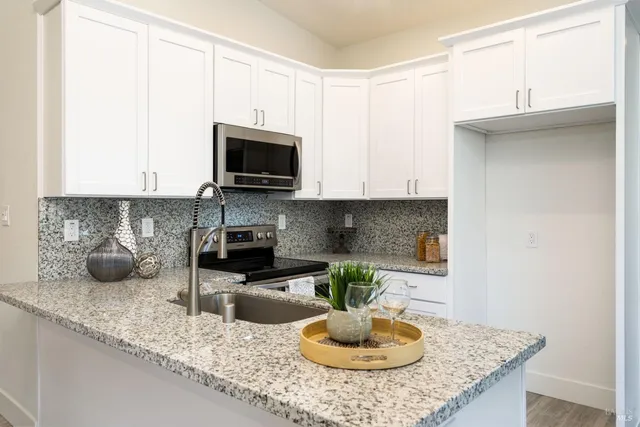 a kitchen with a sink a stove and cabinets