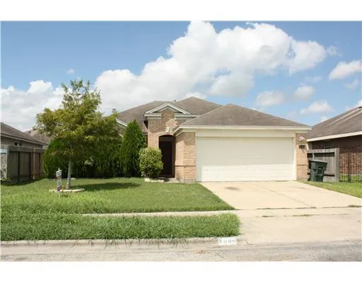 a view of a white house with a big yard and a large tree